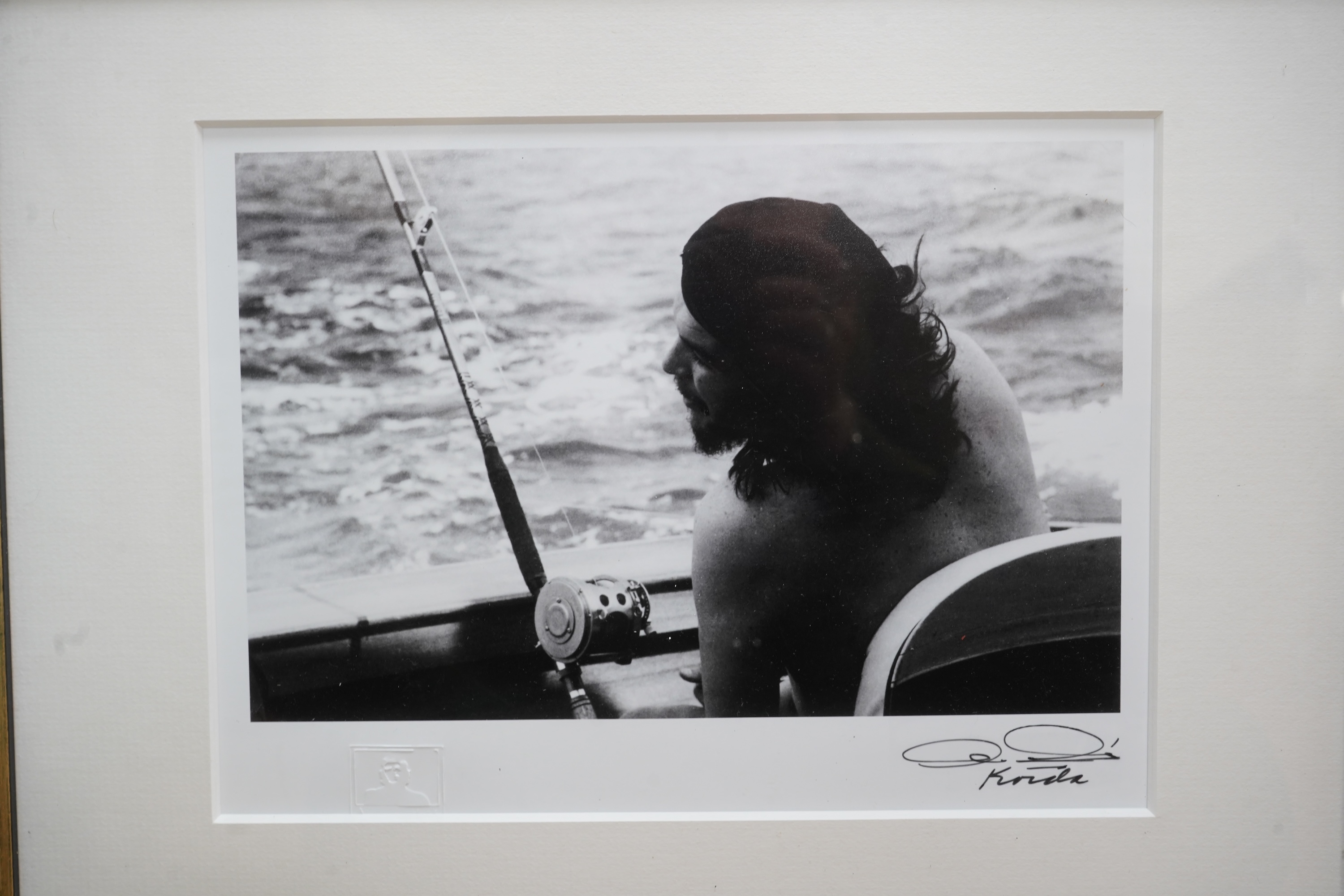 After Alberto Korda (1928-2001), ‘Che Guevara fishing’, stamped, facsimile signature, gelatin silver print, 20 x 26cm